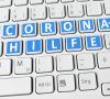 Auf einer Computertastatur steht in blau "Coronahilfe"