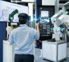 Ingenieur testet 'smart 3D glasses' und scannt  mittels Joystick die Programming eines automatisierten Roboters industry in der 'smart factory'.